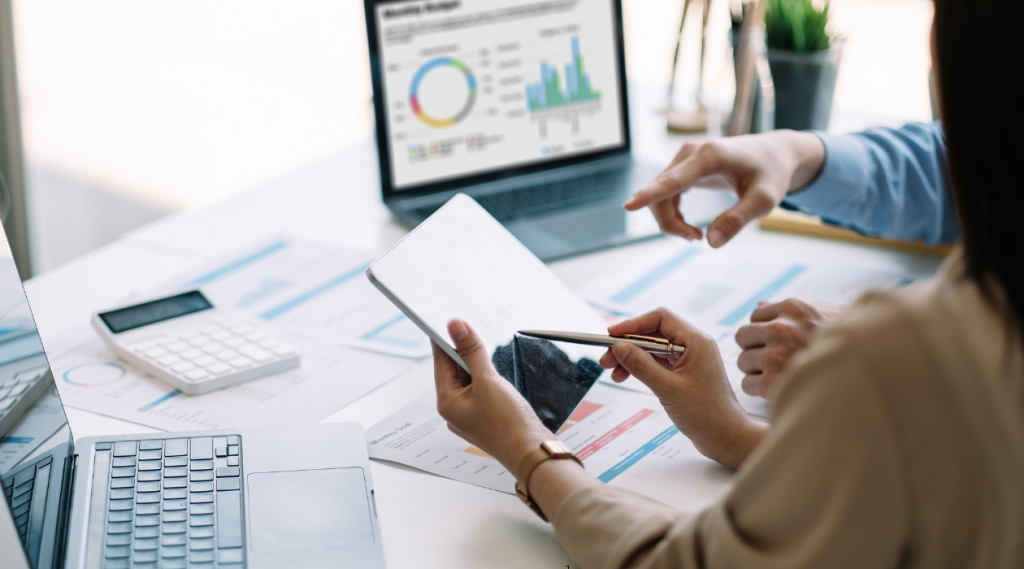 Woman holding tablet reviewing analytics